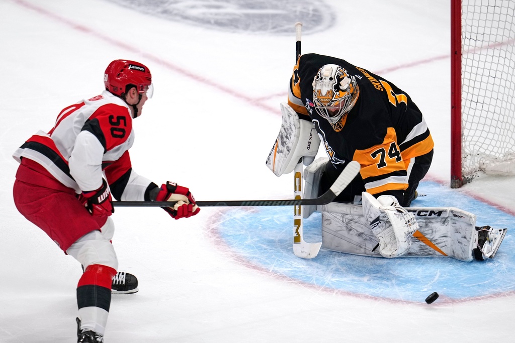 Pittsburgh Penguins goaltender Stuart Skinner (74) blocks a shot by Carolina Hurricanes' Eric Robinson during the first period of an NHL hockey game in Pittsburgh, Tuesday, Dec. 30, 2025. (AP Photo/Gene J. Puskar)
