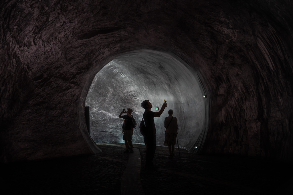 Visitors walk into the artwork "The Pont Neuf Cave" by French street artist JR on the Pont Neuf bridge, Tuesday, June 16, 2026, in Paris, open to the public from June 15 to 28. (AP Photo/Aurelien Morissard)