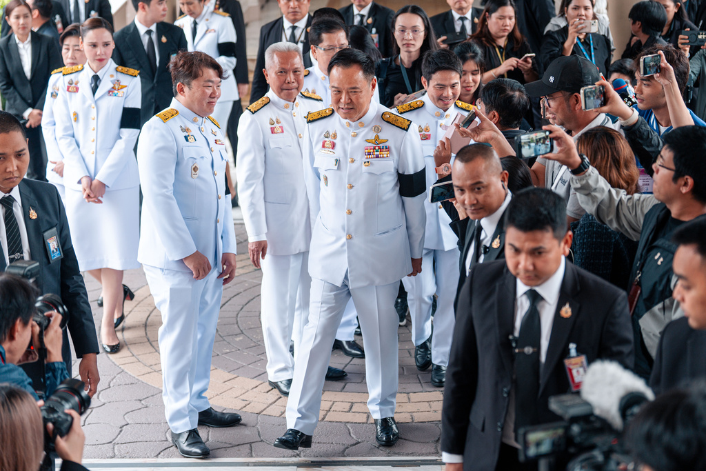 Thailand's Prime Minister Anutin Charnvirakul, center, walks after attending an event at the Government House in Bangkok, Thailand, Friday, Dec. 12, 2025. (AP Photo/Arnun Chonmahatrakool)