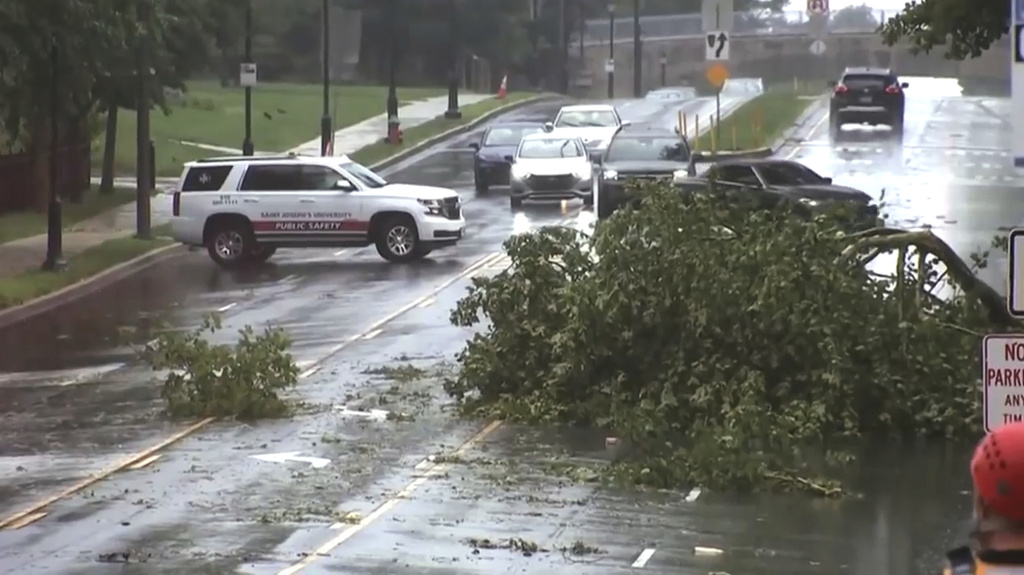 This image taken from video shows a broken tree branch on a street, Sunday, July 12, 2026 after a line of severe, short thunderstorms passed through the city the day before in Philadelphia. (WPVI-TV/6ABC via AP)