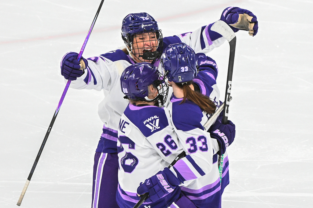 Minnesota Frost's Jincy Roese celebrates with teammates Brooke Becker (15) and Kendall Coyne Schofield (26) after scoring the game winning goal against the Montreal Victoire during overtime in a PWHL playoff hockey game in Laval, Quebec, Saturday, May 2, 2026. (Graham Hughes/The Canadian Press via AP)
