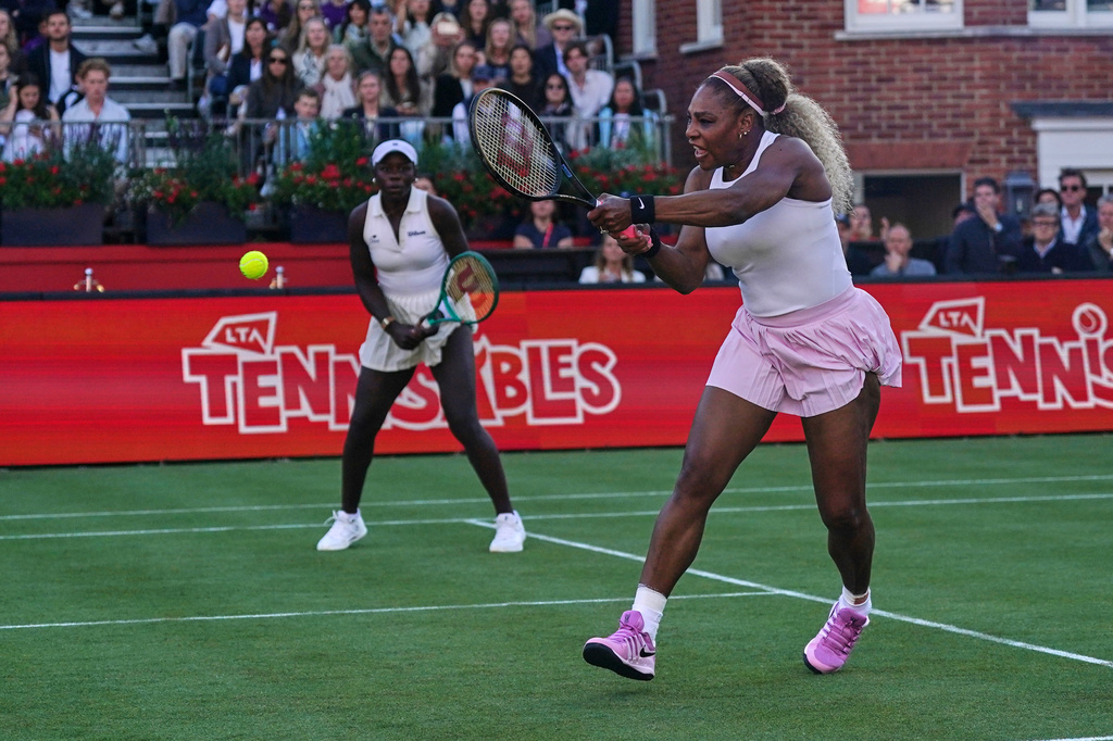 Serena Williams of the United States, right, hits a return as she and playing partner Victoria Mboko of Canada play against Nicole Melichar-Martinez of Canada and Erin Routliffe of New Zealand during their first round doubles match at the Queen's Club tennis championships in London, Tuesday, June 9, 2026. (AP Photo/Alberto Pezzali)