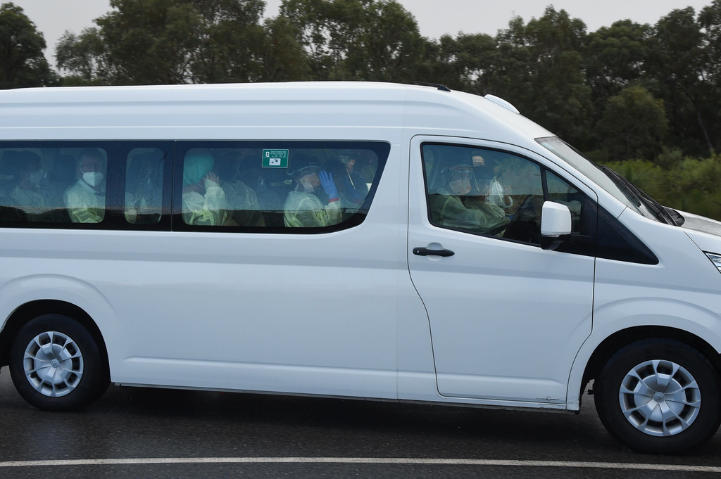 Passengers from the hantavirus-stricken cruise ship MV Hondius are driven in a bus after they arrived in Perth, Australia, from the Netherlands on Friday, May 15, 2026. (Aaron Bunch/AAP Image via AP)