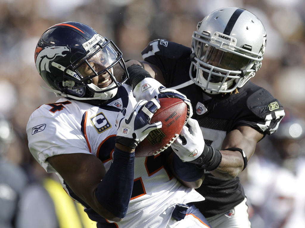 FILE - Denver Broncos cornerback Champ Bailey, right, intercepts a pass intended for Oakland Raiders wide receiver Denarius Moore in the second quarter of an NFL football game in Oakland, Calif., Nov. 6, 2011. (AP Photo/Ben Margot, File)