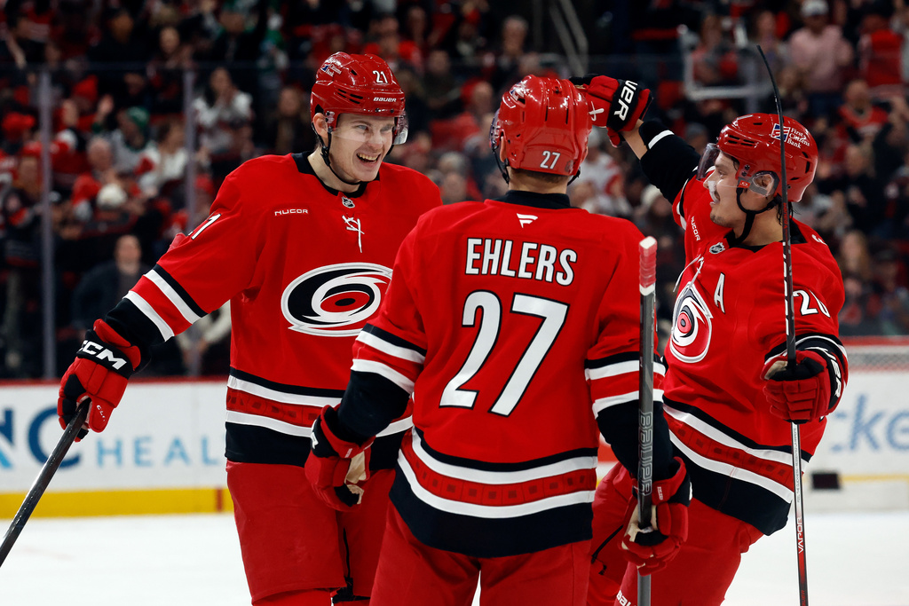 Carolina Hurricanes' Alexander Nikishin celebrates his goal with teammate Sebastian Aho, right, and Nikolaj Ehlers (27) during the second period of an NHL hockey game against the Florida Panthers in Raleigh, N.C., Friday, Jan. 16, 2026. (AP Photo/Karl DeBlaker)