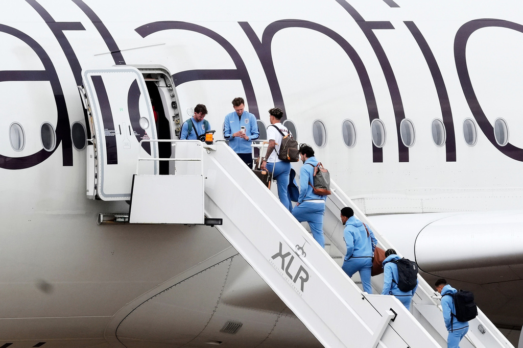 England goalkeeper James Trafford, fourth right and teammates board a plane at Birmingham Airport ahead of the team's departure to the United States for the FIFA World Cup, in Birmingham, England, Monday June 1, 2026. (Nick Potts/PA via AP)