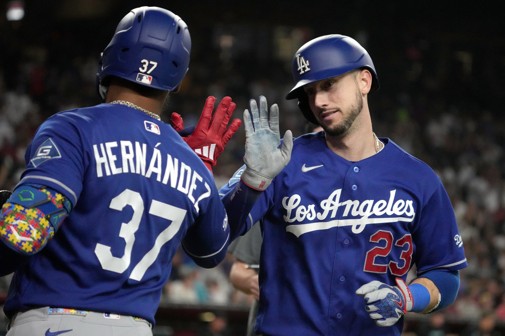 Los Angeles Dodgers' Kyle Tucker celebrates with Teoscar Hernández (37) after hitting a solo home run against the Arizona Diamondbacks in the eighth inning of a baseball game, Saturday, Aug. 8, 2026, in Phoenix. (AP Photo/Rick Scuteri)