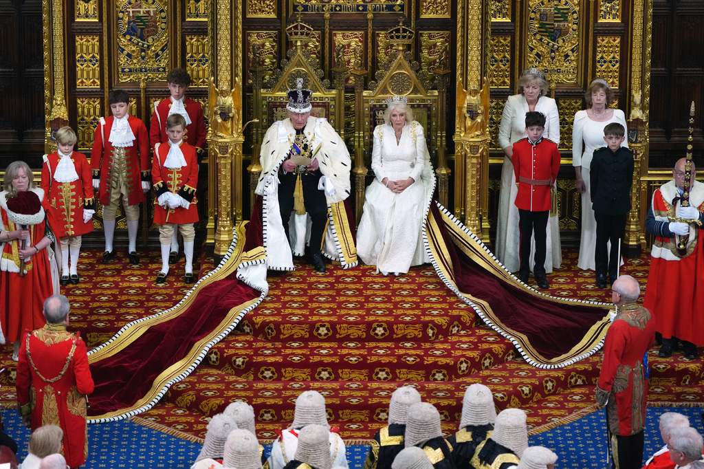 Britain's King Charles III reads out as he sits besides Queen Camilla during the State Opening of Parliament at the Palace of Westminster in London, Wednesday, May 13, 2026.(AP Photo/Kirsty Wigglesworth, Pool)
