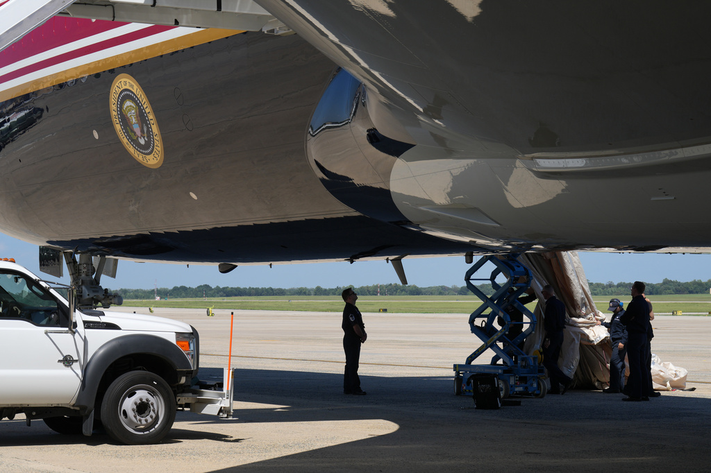 U.S. Air Force personnel work after an emergency inflatable slide deployed on Air Force One before President Donald Trump arrived to board at Joint Base Andrews, Md., Wednesday, Sept. 9, 2026. (AP Photo/Jacquelyn Martin)
