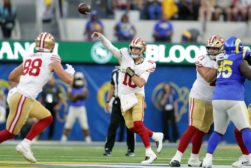 CORRECTS TO INGLEWOOD, CALIF., NOT LOS ANGELES - San Francisco 49ers' Mac Jones, center, throws a pass against the Los Angeles Rams during the first quarter of an NFL football game in Inglewood, Calif., Thursday, Oct. 2, 2025. (Scott Strazzante/San Francisco Chronicle via AP)