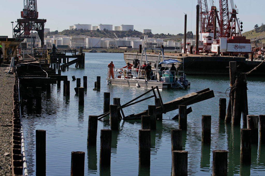 FILE - A barge of scientists and divers move into position to gather samples at the former United Heckathorn DDT processing plant and shipping terminal in Richmond, Calif., March 8, 2012. (AP Photo/Eric Risberg, File)