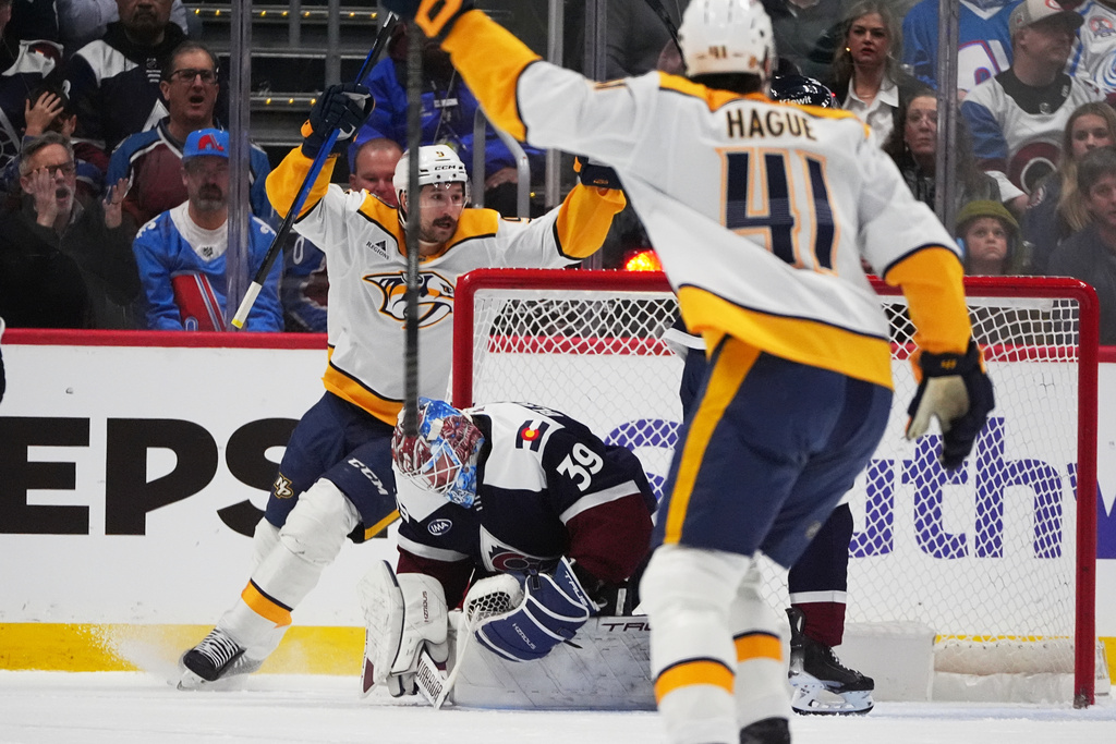 Nashville Predators defenseman Nicolas Hague (41) and left wing Filip Forsberg, back left, celebrate after a goal by center Ryan O'Reilly (not shown) past Colorado Avalanche goaltender MacKenzie Blackwood (39) in the first period of an NHL hockey game Friday, Jan. 16, 2026, in Denver. (AP Photo/David Zalubowski)