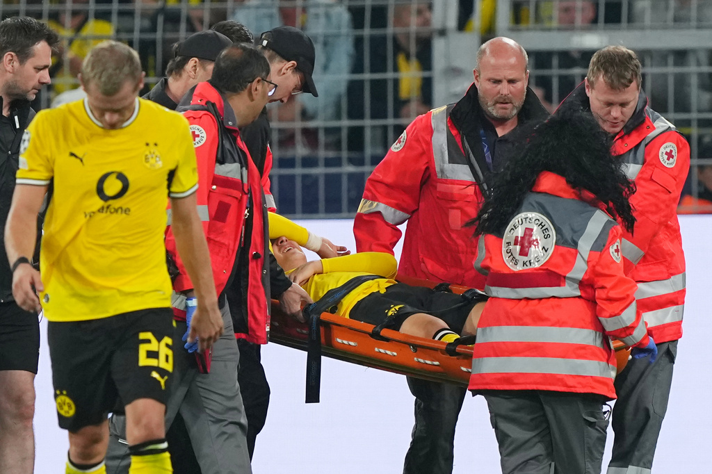 Dortmund's Konstantinos Karetsas is carried off the pitch by medical staff during the Champions League opening phase soccer match between Borussia Dortmund and Villarreal in Dortmund, Germany, Tuesday, Sept. 8, 2026. (AP Photo/Martin Meissner)