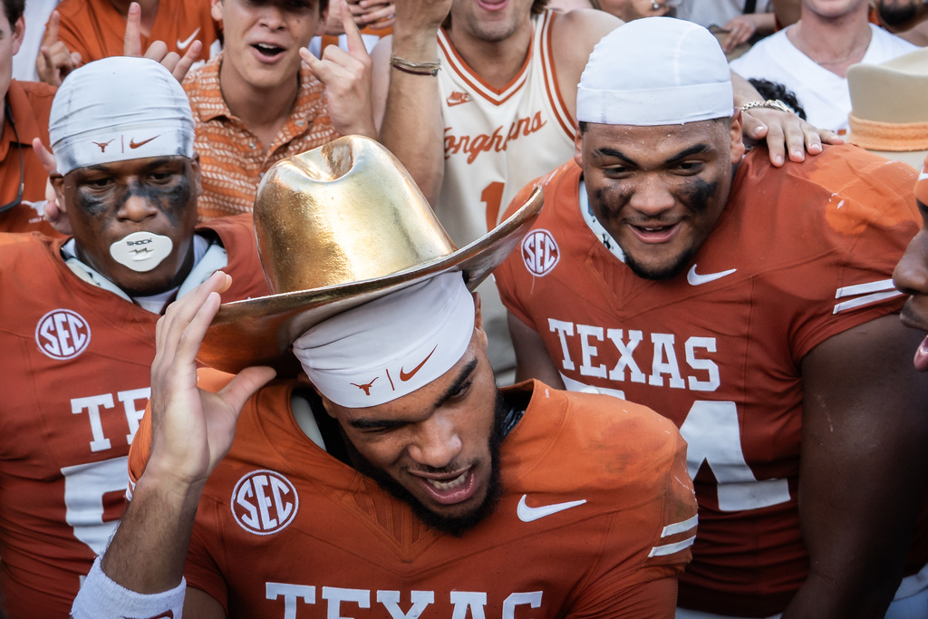 Texas wide receiver DeAndre Moore Jr. (0) celebrates beating Oklahoma in an NCAA college football game at the Cotton Bowl in Dallas, Saturday, Oct. 11, 2025. (Sara Diggins/Austin American-Statesman via AP)