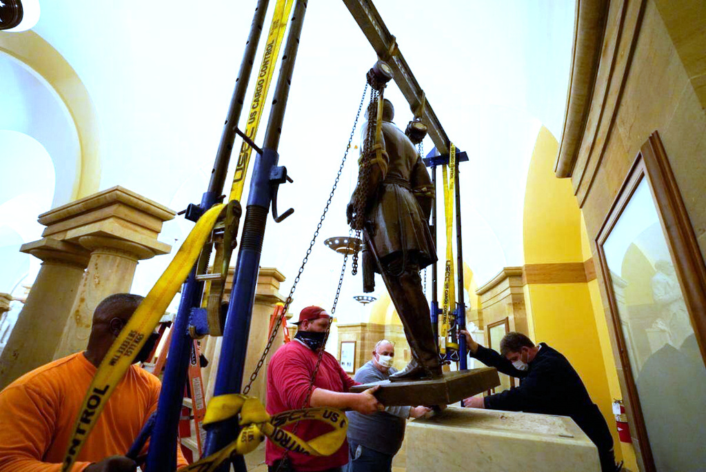 FILE - This Monday, Dec. 21, 2020 photo provided by the Office of the Governor of Virginia shows workers removing a statue of Confederate Gen. Robert E. Lee from the National Statuary Hall Collection in Washington. (Jack Mayer/Office of Governor of Virginia, File)