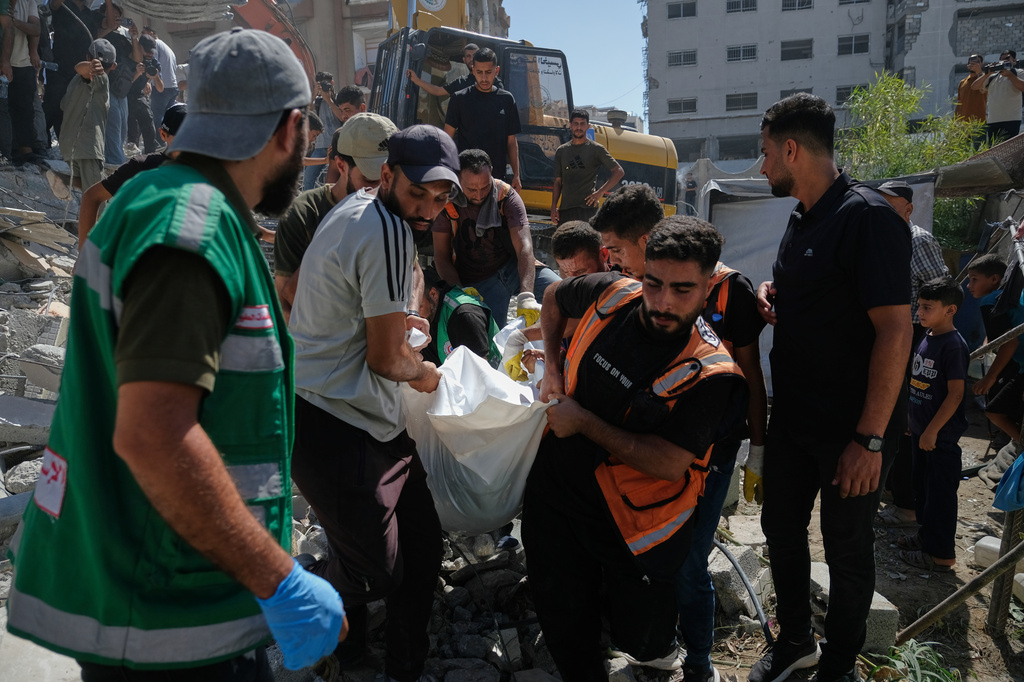 Palestinian civil defense crews carry a body from the rubble of a collapsed building that housed displaced Palestinians and was heavily damaged during the Israel-Hamas war, in Gaza City, Wednesday, Sept. 16, 2026. (AP Photo/Jehad Alshrafi)