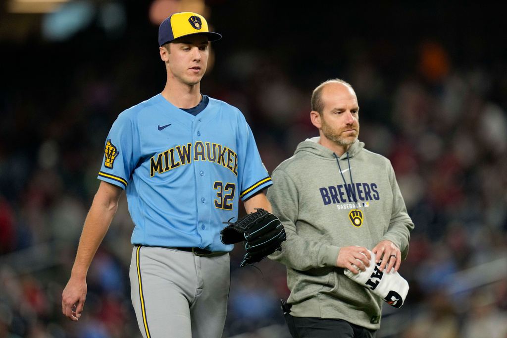 Milwaukee Brewers starting pitcher Jacob Misiorowski (32) walks to the dugout with head trainer Brad Epstein, right, as he exits due to an apparent injury during the sixth inning of a baseball game against the Washington Nationals, Friday, May 1, 2026, in Washington. (AP Photo/Jess Rapfogel)