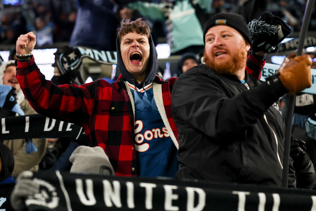 Minnesota United fans celebrate after the team scored during the second half of Game 3 in the first round of MLS soccer's Western Conference playoffs against the Seattle Sounders in St. Paul, Minn., Saturday, Nov. 8, 2025. (AP Photo/Ellen Schmidt)