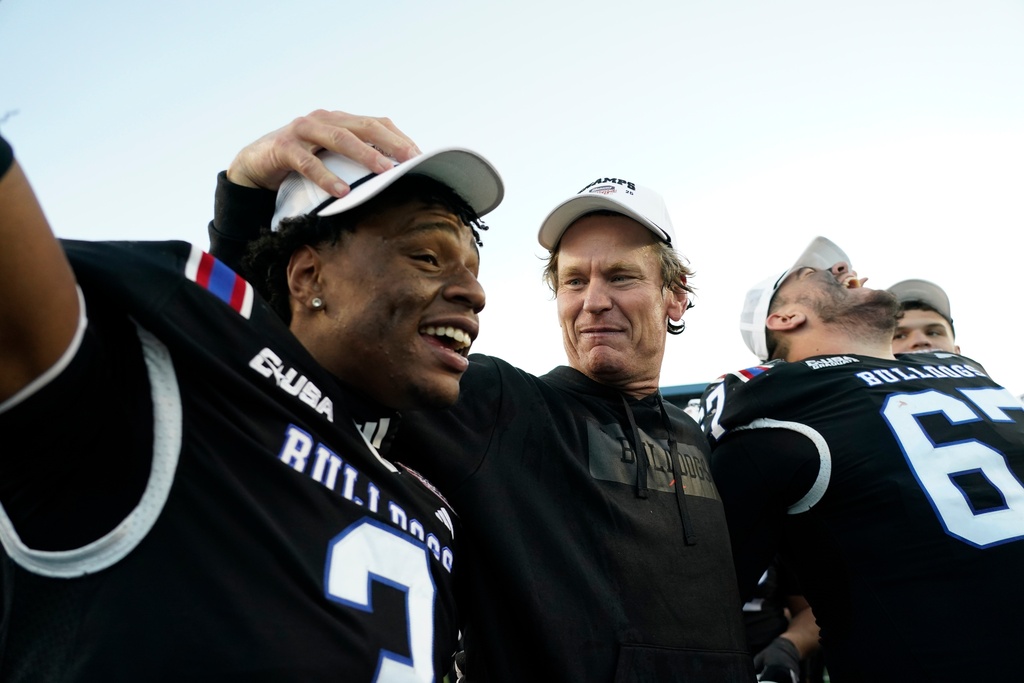 Louisiana Tech head coach Sonny Cumbie celebrates with his players following their win over Coastal Carolina in the Independence Bowl NCAA college football game, Tuesday, Dec. 30, 2025, in Shreveport, La. (AP Photo/Rogelio V. Solis)