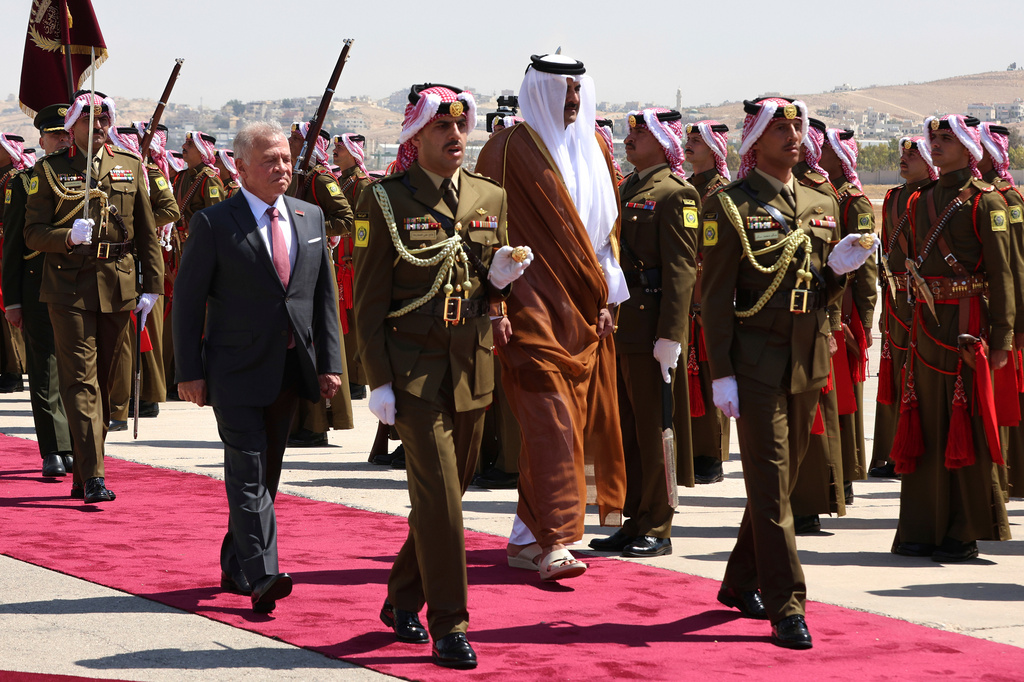 FILE - Jordan's King Abdullah II, left, and Qatar's Emir Tamim bin Hamad Al-Thani, review an honour guard during a welcome ceremony in Amman, Jordan, Wednesday, Sept. 17, 2025. (AP Photo/Raad Adayleh, File)