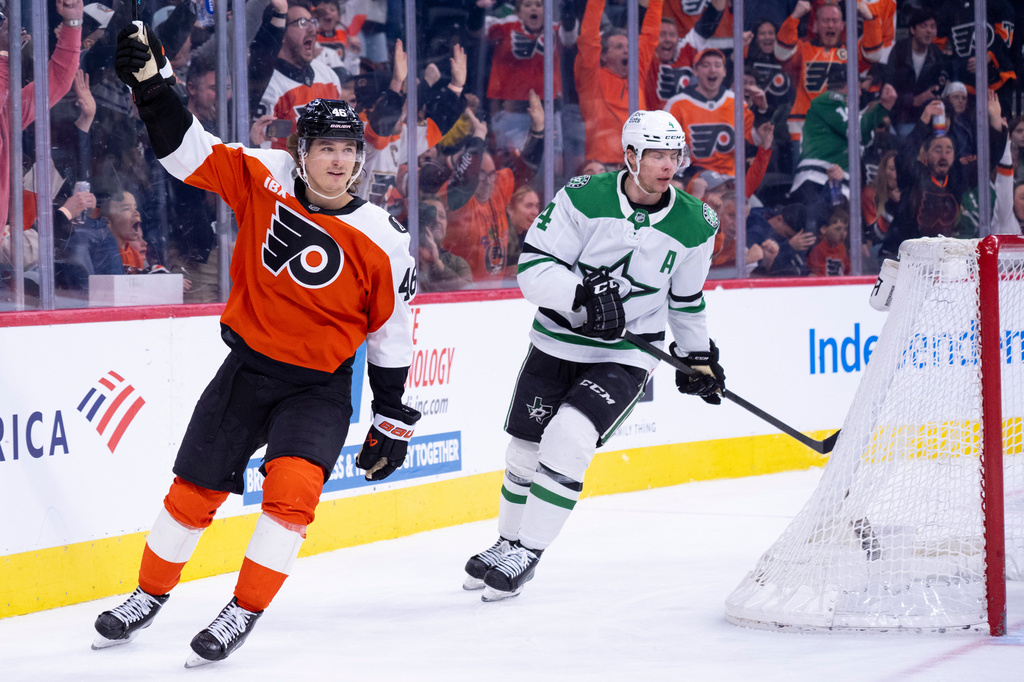 Philadelphia Flyers center Trevor Zegras, left, reacts to his game winning goal as Dallas Stars defenseman Miro Heiskanen, right, looks on during overtime of an NHL hockey game, Sunday, March 29, 2026, in Philadelphia. (AP Photo/Chris Szagola)