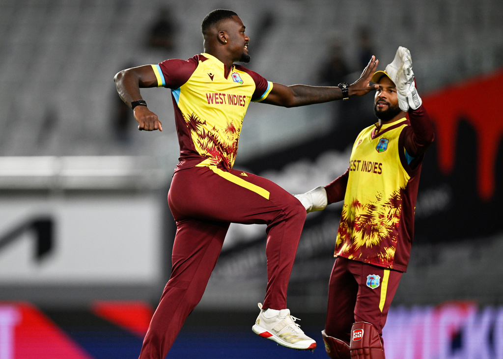 West Indies bowler Jayden Seales celebrates with teammate Shai Hope, right, after taking the wicket of New Zealand's Michael Bracewell during the T20 cricket international between New Zealand and the West Indies in Auckland, New Zealand, Wednesday, Nov. 5, 2025. (Andrew Cornaga/Photosport via AP)