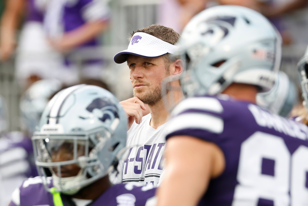 In his first game as Kansas State head coach, Collin Klein, center, watches his players warm up before an NCAA college football game against Nicholls in Manhattan, Kan., Saturday, Sept. 5, 2026. (AP Photo/Colin E. Braley)