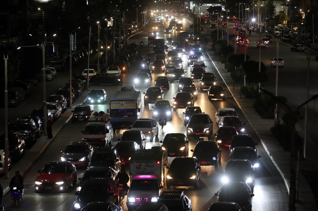 Vehicles drive as light poles are reduced to save electricity, as part of a series of measures the government has taken to mitigate the fallout of the U.S. and Israeli war against Iran, in Cairo, Egypt, Sunday, March 29, 2026. (AP Photo/Khaled Elfiqi)