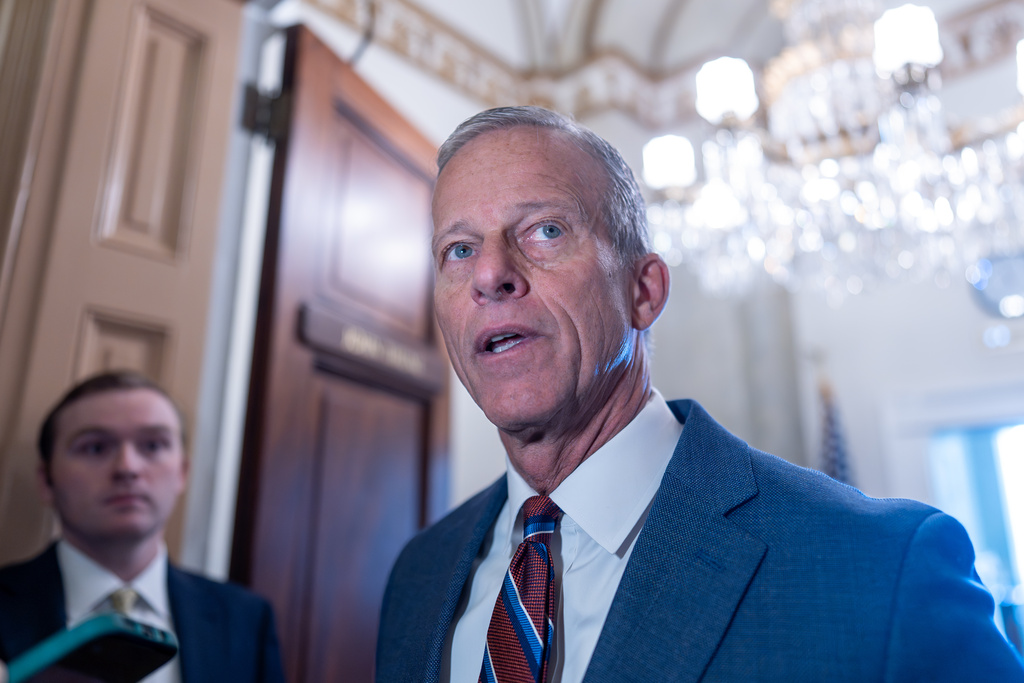 Senate Majority Leader John Thune, R-S.D., speaks to reporters as he arrives at his office following a weekend vote to move forward with a stopgap funding bill to reopen the government through Jan. 30, at the Capitol in Washington, Monday, Nov. 10, 2025. (AP Photo/J. Scott Applewhite)