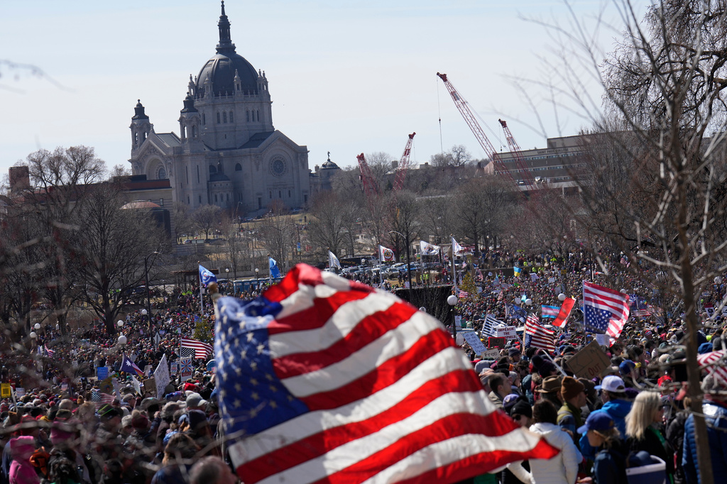People take part in a "No Kings" protest Saturday, March 28, 2026, in St. Paul, Minn. (AP Photo/Joe Scheller)