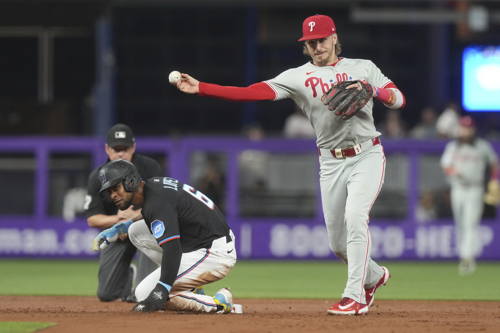 Philadelphia Phillies second baseman Bryson Stott throws to first base to complete the double play during the first inning of a baseball game against the Miami Marlins Friday, Sept. 5, 2025, in Miami. (AP Photo/Marta Lavandier)