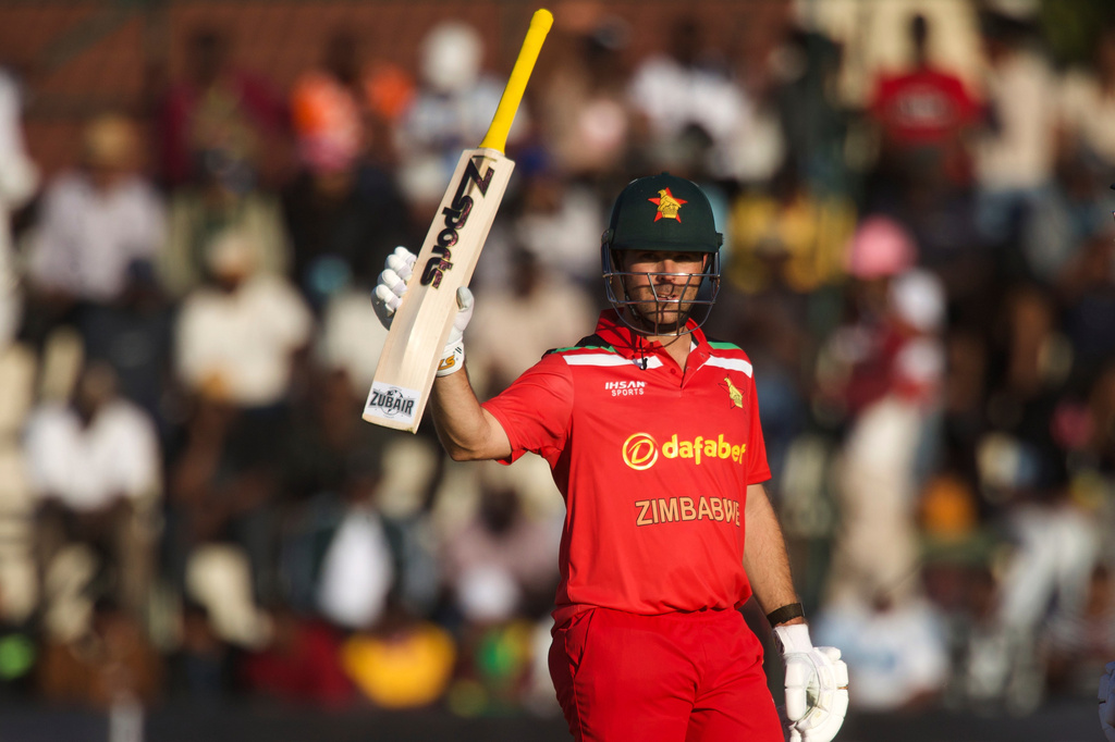 Zimbabwe's batsman Ryan Burl raises his bat after scoring 50 runs during the third T20 cricket match between Zimbabwe and India in Harare, Zimbabwe, Sunday, July 26, 2026. (AP Photo/Wonder Mashura)