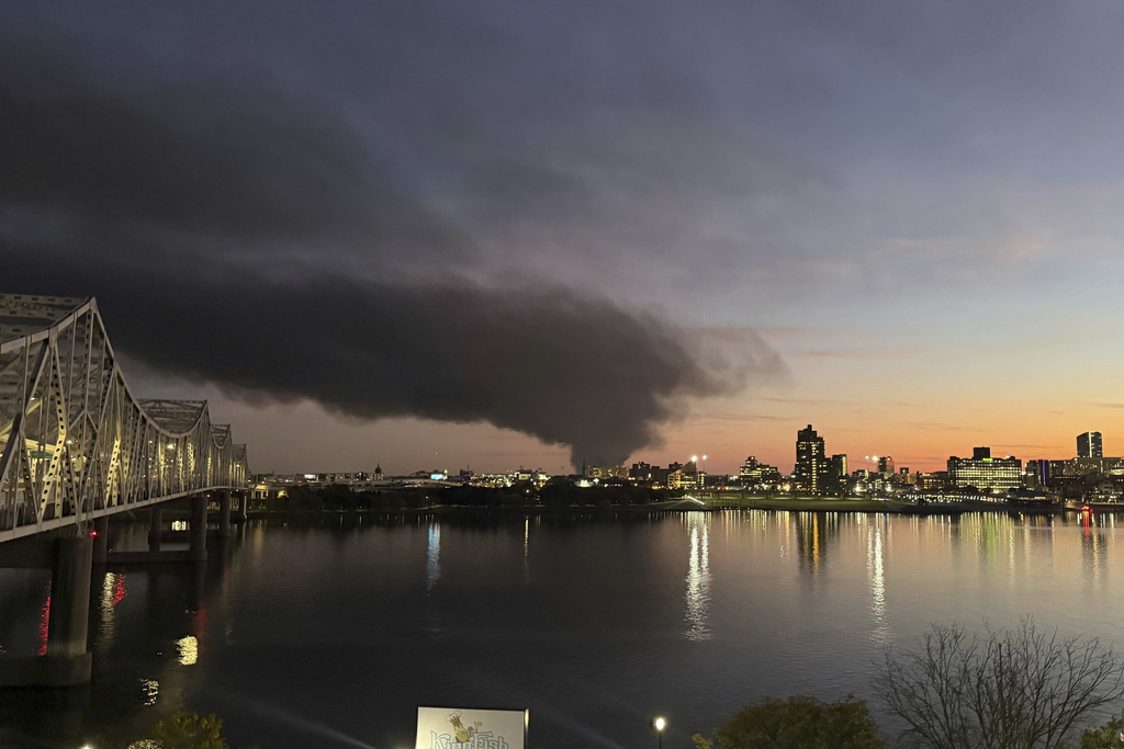This photo provided by Chuck Fugate shows thick, black smoke rising after reports of a plane crash at Louisville International Airport, Tuesday, Nov. 4, 2025, as seen from Fugate's condo in Jeffersonville, Ind. (Chuck Fugate via AP)