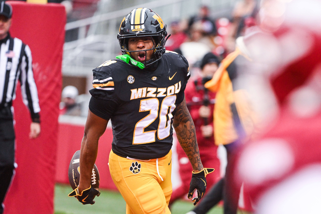 Missouri running back Jamal Roberts (20) celebrates after running for a touchdown against Arkansas during the first half of an NCAA college football game, Saturday, Nov. 29, 2025, in Fayetteville, Ark. (AP Photo/Michael Woods)