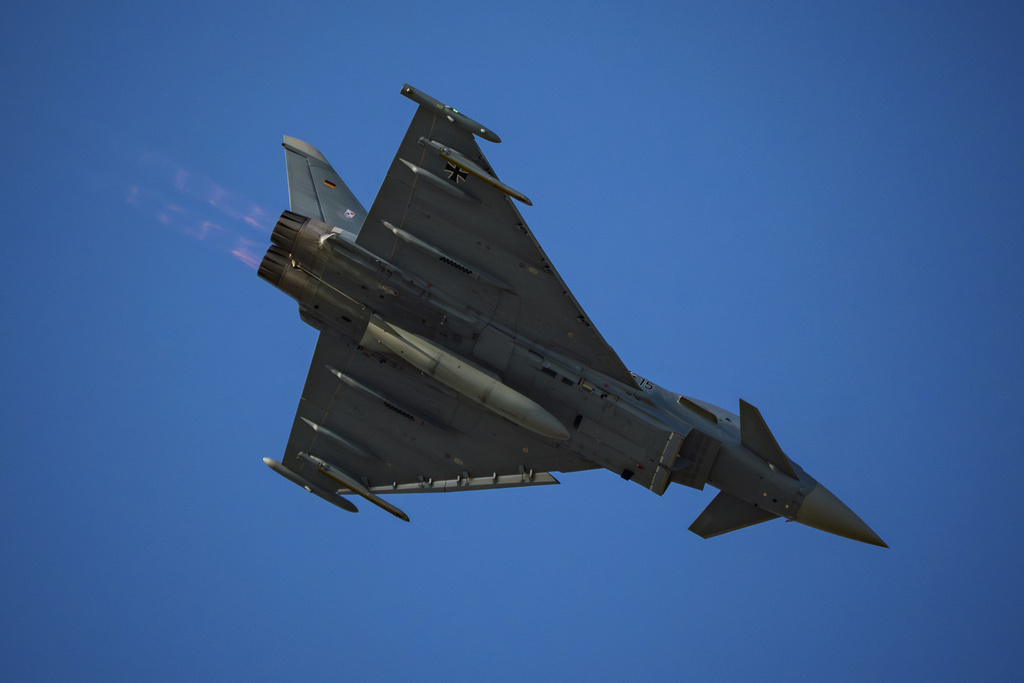 An Eurofighter Typhoon German Air Force fighter jet flies above the runway of the Aurel Vlaicu airport, on the first day of the Bucharest International Air Show, BIAS, in Bucharest, Romania, Saturday, Aug. 30, 2025. (AP Photo/Andreea Alexandru)