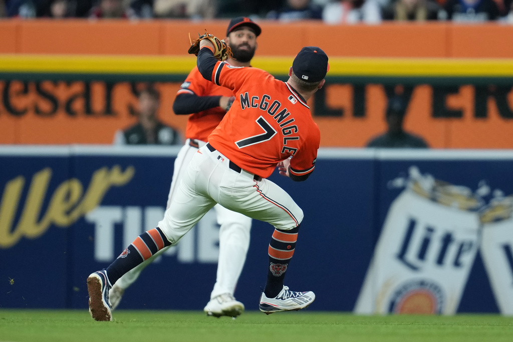 Detroit Tigers left fielder Riley Greene and shortstop Kevin McGonigle (7) let a Miami Marlins' Connor Norby fly ball land for a double during the fifth inning of a baseball game Friday, April 10, 2026, in Detroit. (AP Photo/Paul Sancya)