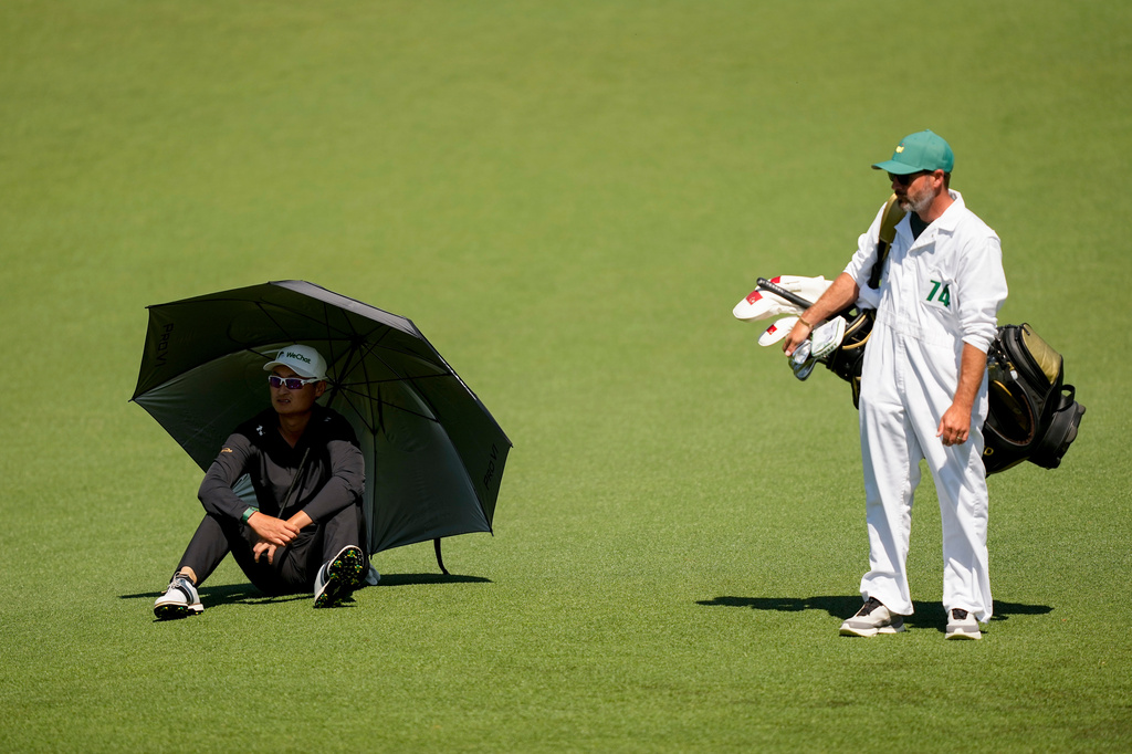 Haotong Li, of China, waits to play on the second hole during the second round of the Masters golf tournament at the Augusta National Golf Club, Friday, April 10, 2026, in Augusta, Ga. (AP Photo/Gerald Herbert)