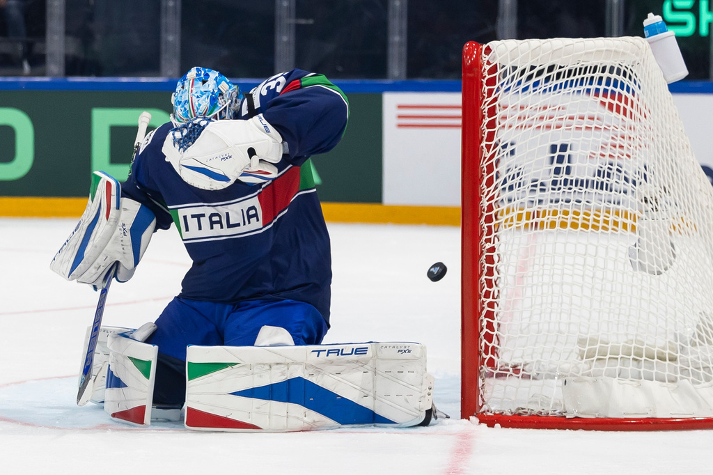 Italy's goaltender Davide Fadani concedes a goal 0:3 during the 2026 IIHF Men's Ice Hockey World Championship preliminary round group B game between Italy and Canada, in Fribourg, Switzerland, Saturday, May 16, 2026. (Cyril Zingaro/Keystone via AP)
