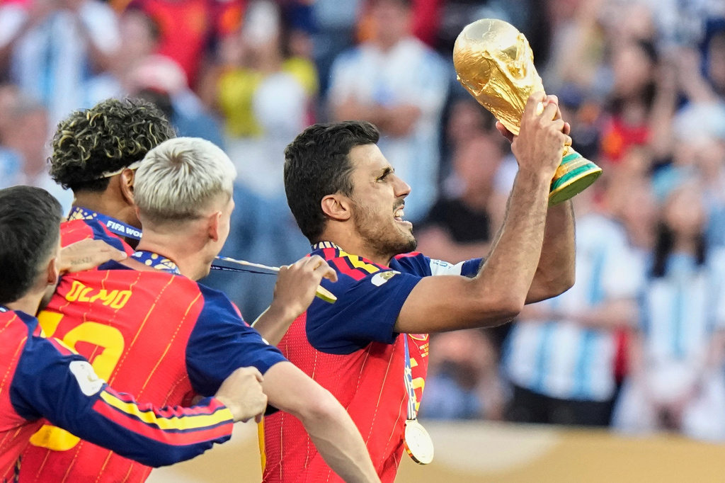 Spain's Rodri (16) lifts the winners' trophy after their win in the World Cup final soccer match against Argentina in East Rutherford, N.J., near New York, Sunday, July 19, 2026. (AP Photo/Frank Franklin II)