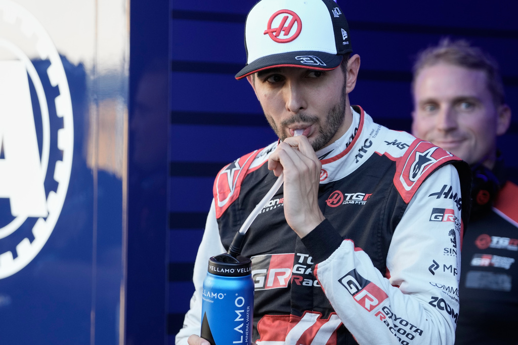 Haas driver Esteban Ocon of France walks through the paddock after failing to advance during the qualifying session for the Spanish Formula One Grand Prix in Madrid, Saturday, Sept. 12, 2026. (AP Photo/Bernat Armangue)