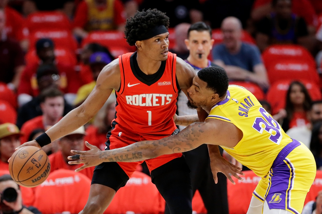 Houston Rockets guard Amen Thompson (1) looks to drive around Los Angeles Lakers guard Marcus Smart (36) who reaches in during the first half of Game 3 in a first-round NBA playoffs basketball series Friday April 24, 2026, in Houston. (AP Photo/Michael Wyke)