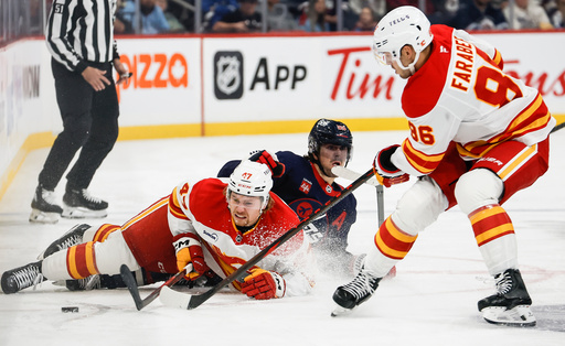 Winnipeg Jets' Mark Scheifele (centre) and Calgary Flames' Connor Zary (left) collide as Joel Farabee (86) picks up the loose puck during first period NHL action in Winnipeg on Friday, Oct. 24, 2025. (John Woods/The Canadian Press via AP) Winnipeg Jets' Mark Scheifele (centre) and Calgary Flames' Connor Zary (left) collide as Joel Farabee (86) picks up the loose puck during first period NHL action in Winnipeg on Friday, Oct. 24, 2025. (John Woods/The Canadian Press via AP)