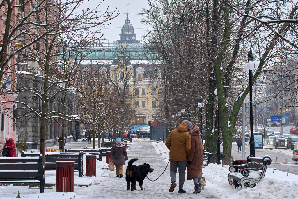 A couple share a tender moment as they walk on a snowy street in Kyiv, Ukraine, Thursday, Jan. 8, 2026, as Ukraine faces harsh weather amid Russia's regular missile attacks on the country's energy system. (AP Photo/Efrem Lukatsky)