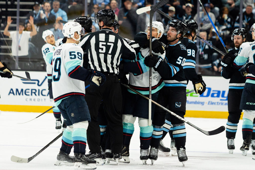 Seattle Kraken fight on the ice against the Utah Mammoth during the second period of an NHL hockey game Saturday, Jan. 17, 2026, in Salt Lake City. (AP Photo/Melissa Majchrzak)