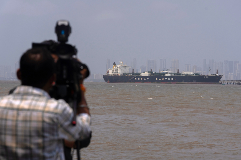 A cameraman films the Indian flagged LPG carrier Jag Vasant transporting liquefied petroleum gas, at the Mumbai Port in Mumbai, India, after it arrived clearing the Strait of Hormuz, Wednesday, April 1, 2026.(AP Photo/Rafiq Maqbool)