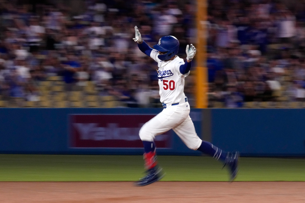 Los Angeles Dodgers' Mookie Betts celebrates after hitting a two-run home run during the third inning of a baseball game against the Cincinnati Reds, Wednesday, Sept. 9, 2026, in Los Angeles. (AP Photo/Mark J. Terrill)