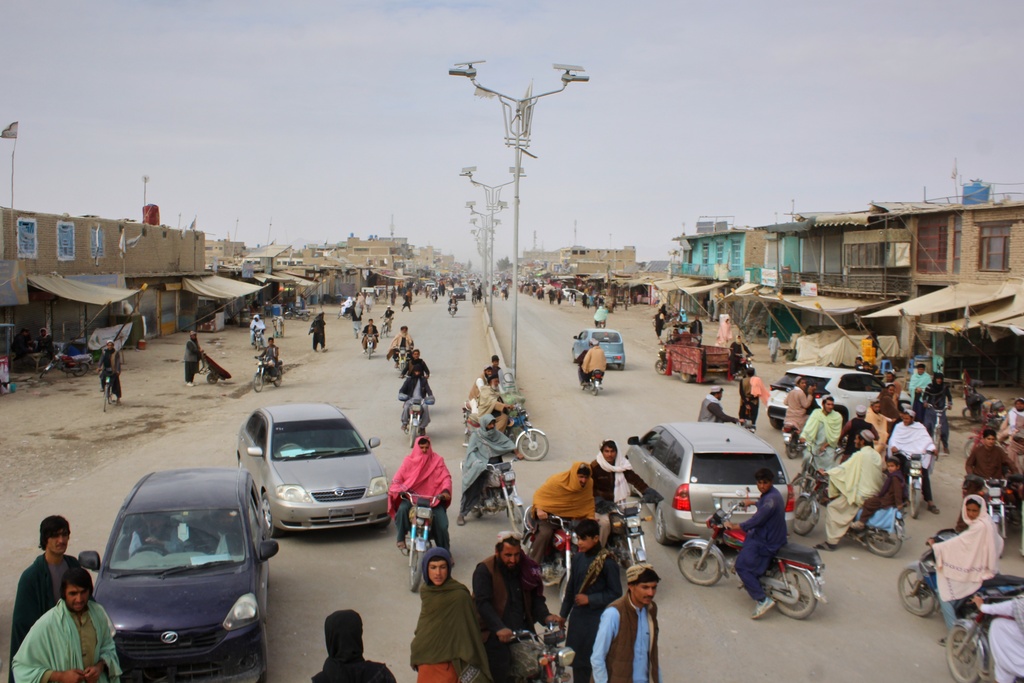 Vehicles drive along a street in the aftermath of an overnight exchange of fire between Afghan and Pakistani forces along the border in Spin Boldak, Kandahar province, Afghanistan, Saturday, Dec. 6, 2025. (AP Photo/Sibghatullah)