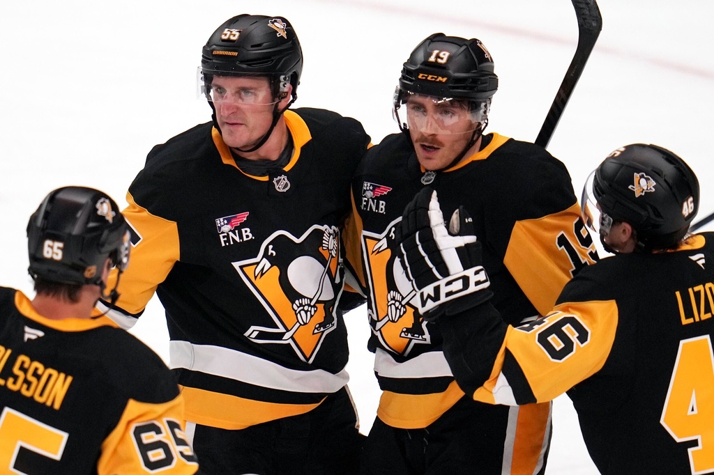 Pittsburgh Penguins' Connor Dewar (19) celebrates his goal during the first period of an NHL hockey game against the Vancouver Canucks in Pittsburgh, Tuesday, Oct. 21, 2025. (AP Photo/Gene J. Puskar)