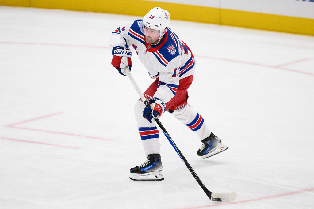 New York Rangers left wing Alexis Lafrenière (13) skates with the puck during the third period of an NHL hockey game against the Washington Capitals, Wednesday, Dec. 31, 2025, in Washington. (AP Photo/Nick Wass)