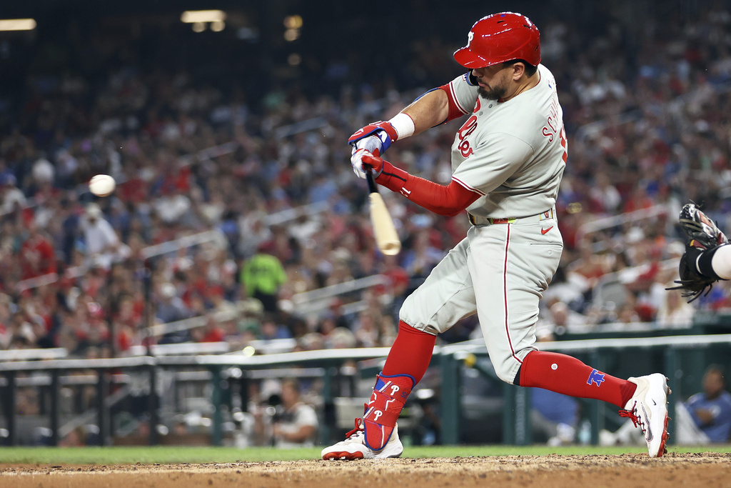 Philadelphia Phillies' Kyle Schwarber hits a home run during the seventh inning of a baseball game against the Washington Nationals, Friday, Aug. 15, 2025, in Washington. (AP Photo/Daniel Kucin Jr.)